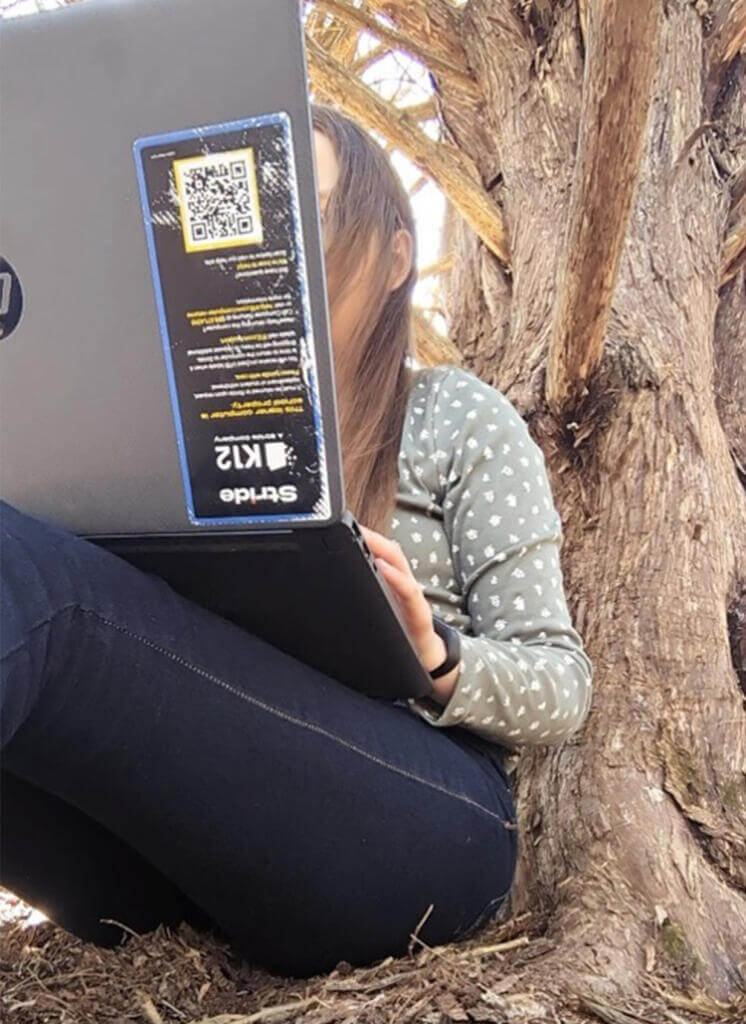 girl reading under a tree